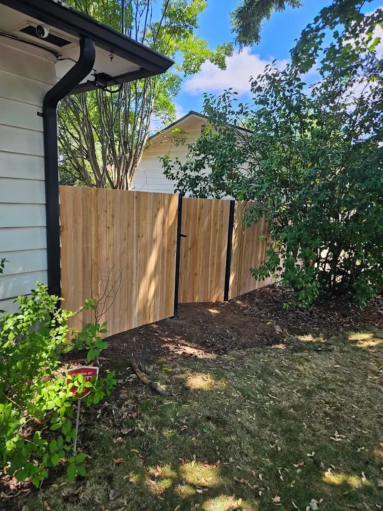 Homeowner reviewing the completed fence with the crew