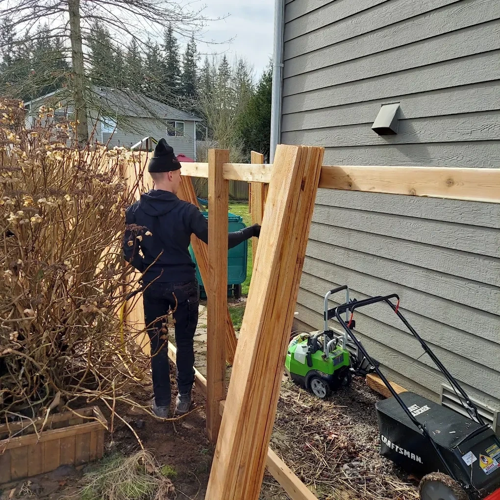 Terek Fencing crew installing cedar fence posts on site