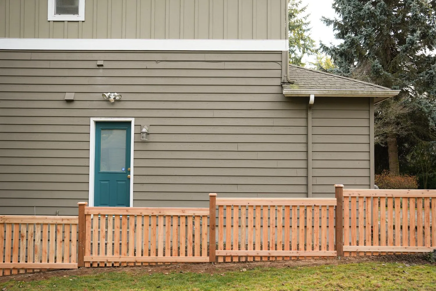 Low wooden picket fence installed in a side of a two-storey Vancouver home
