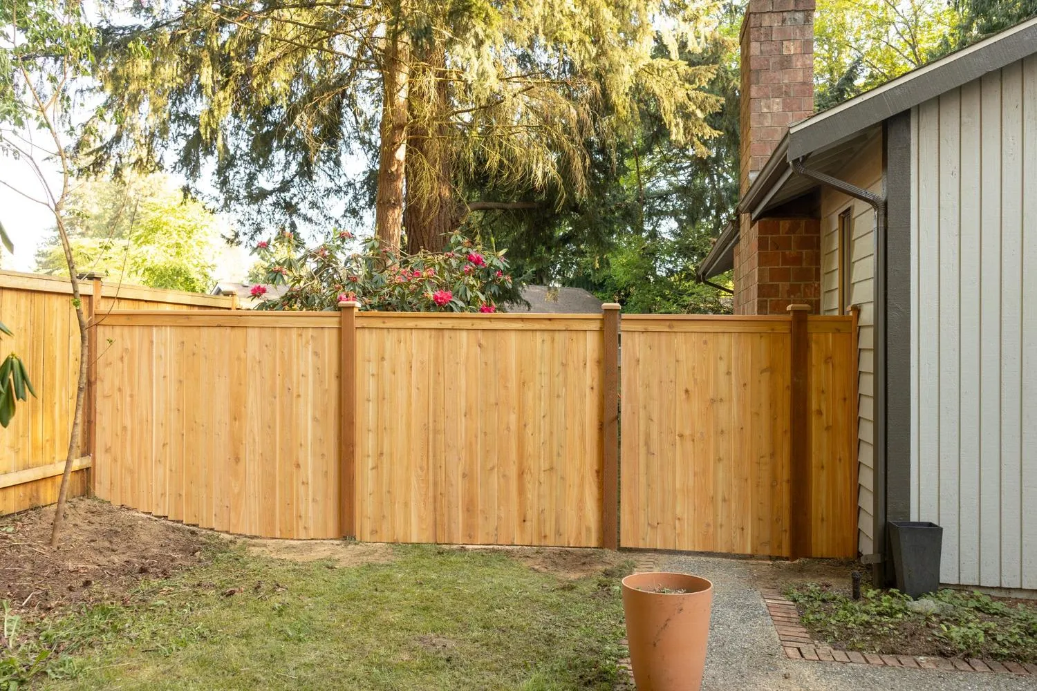 Cedar fence with gate built near a bungalow in Southwest Washington