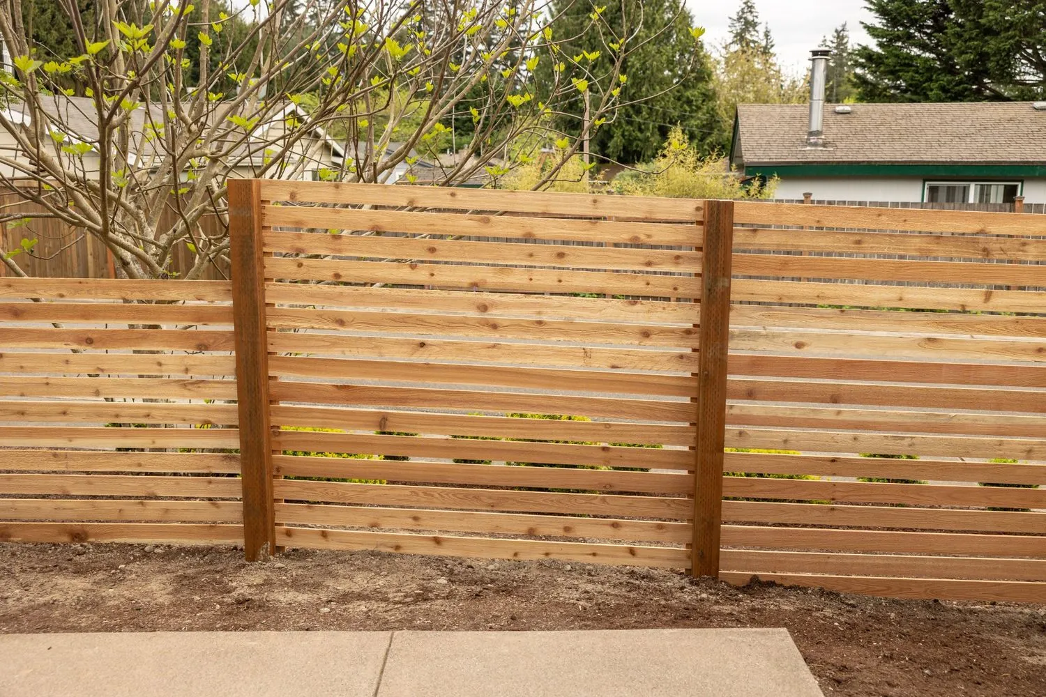 Horizontal wooden fence with minimal slats for airflow in SW Washington