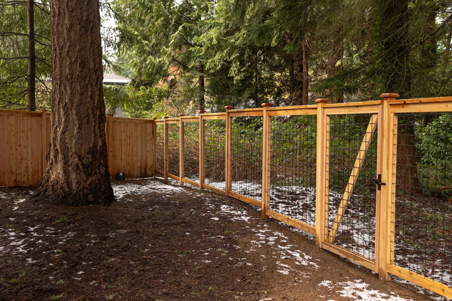 Ongoing fence installation during winter at a Clark County property