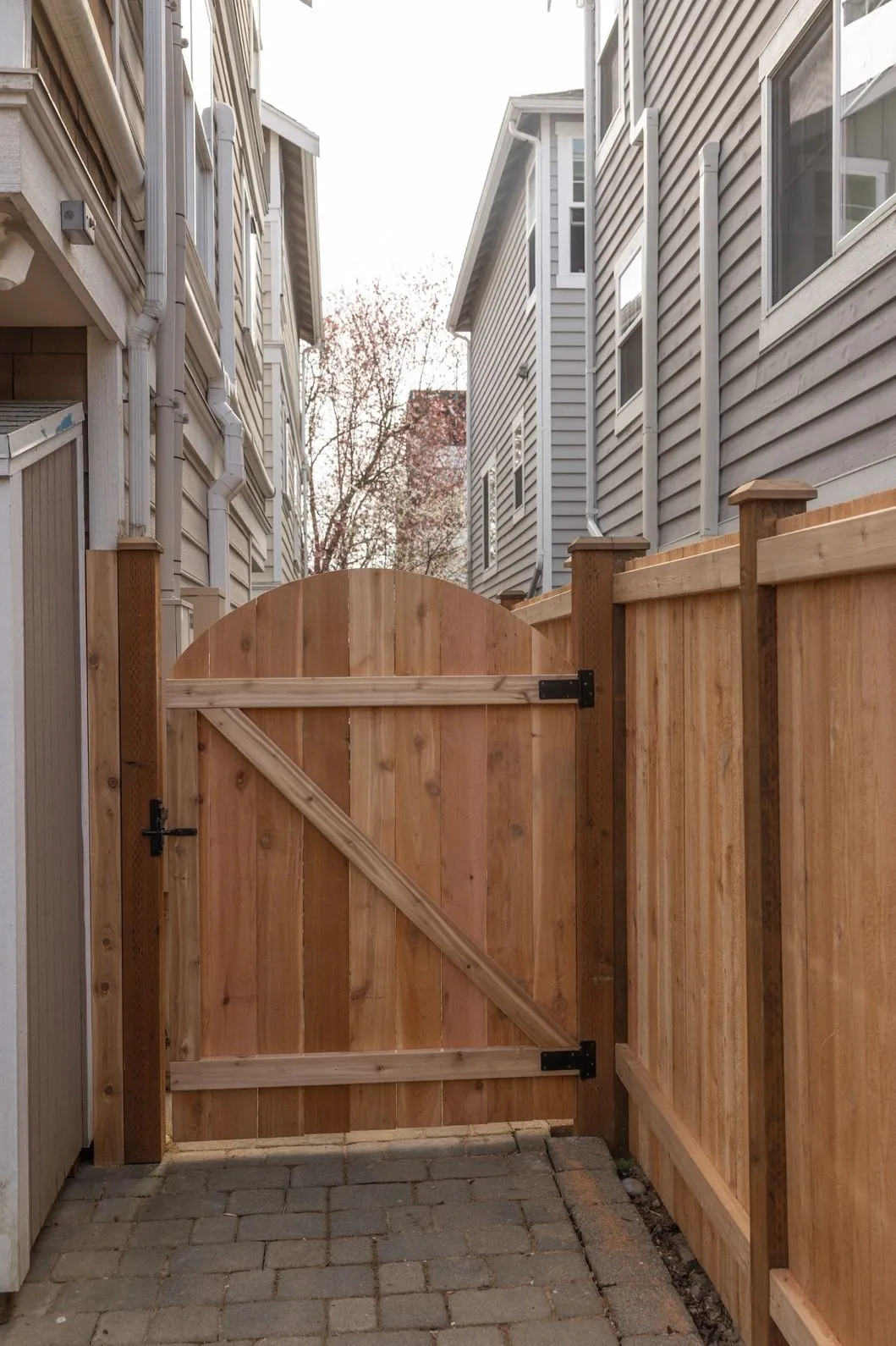 Wooden fence and gate leading to an alley in a Portland residential area