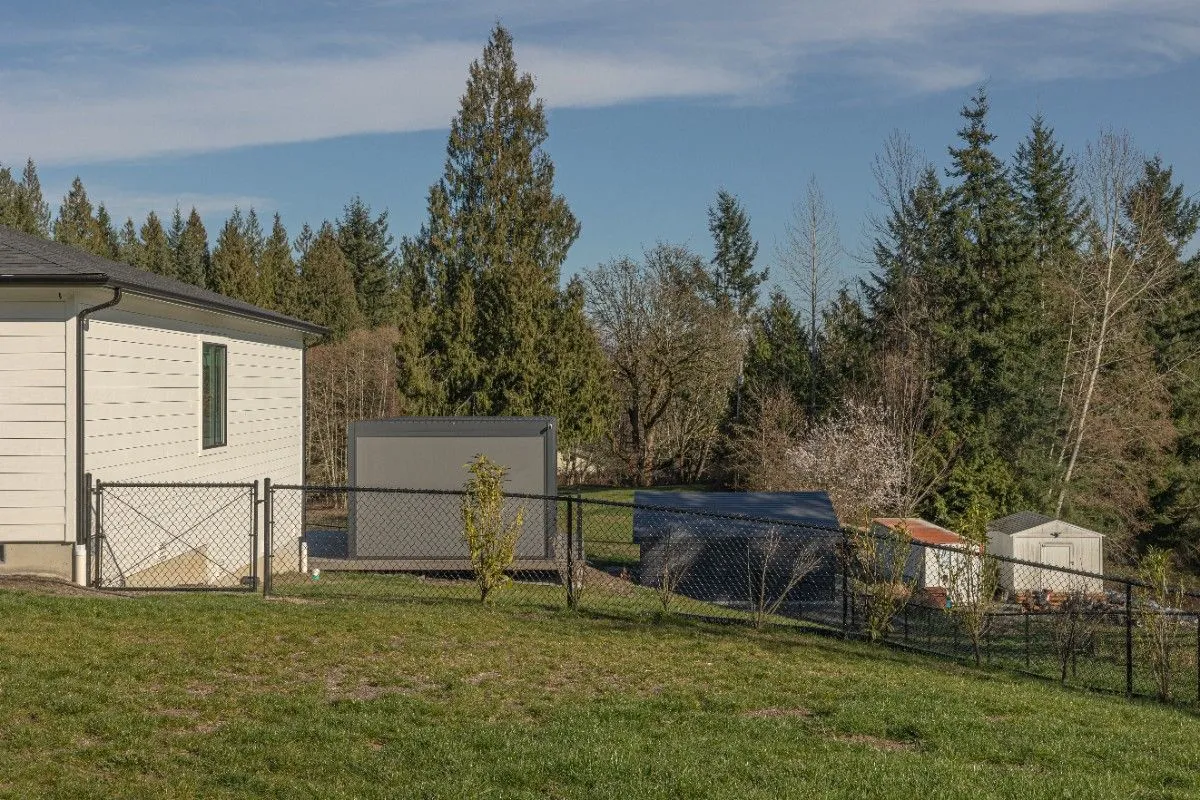Black vinyl-coated chain link fence installed beside a home in Clark County