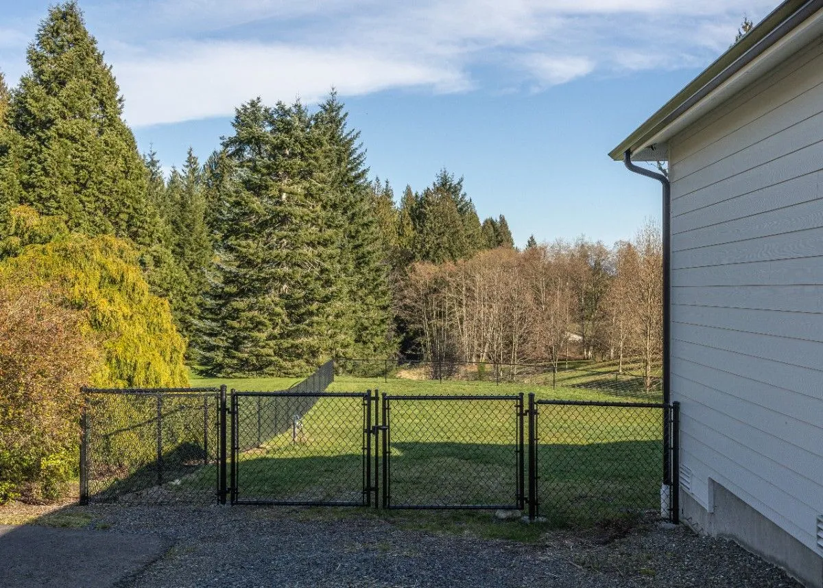 Black vinyl-coated chain link fence with gate in a ranch in Clark County