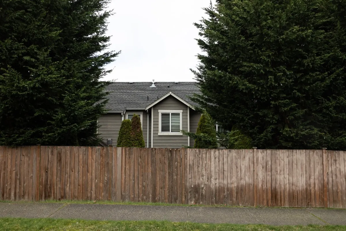 Old and faded wooden fence in Vancouver showing signs of damage