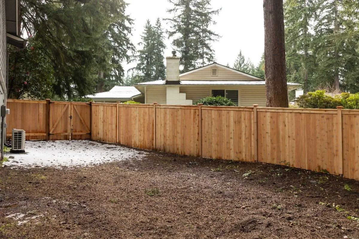 Wooden privacy fence installed in a remote Oregon home during winter