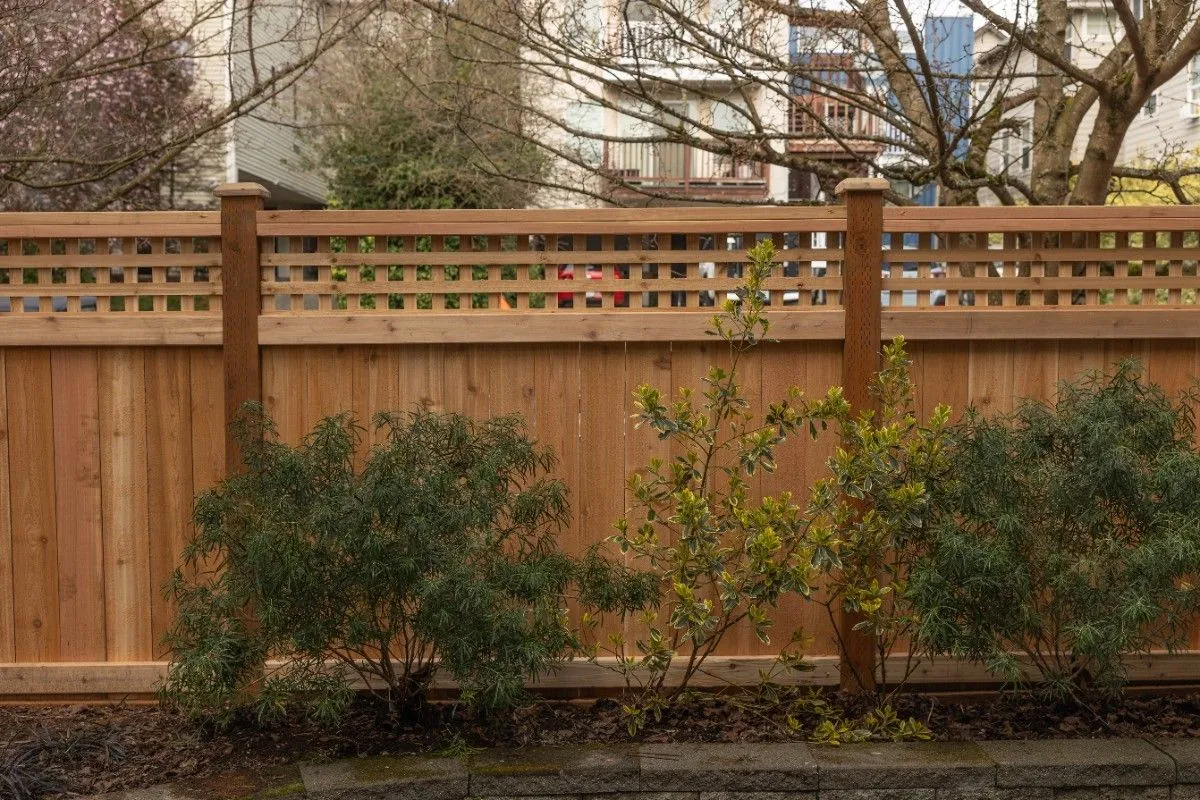 A sturdy wooden fence built near a plant box in Portland