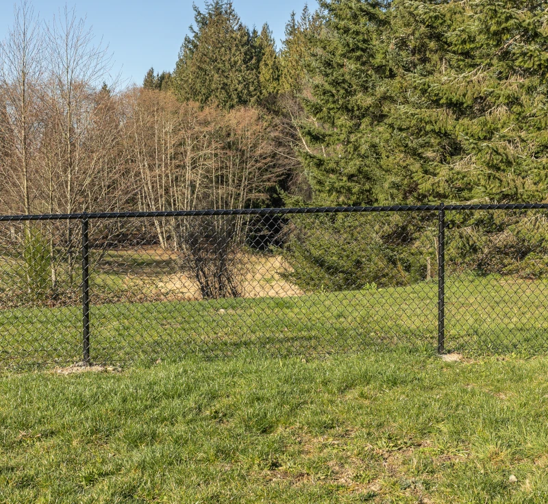 A black chain link fence carefully set deep in a ground in Vancouver