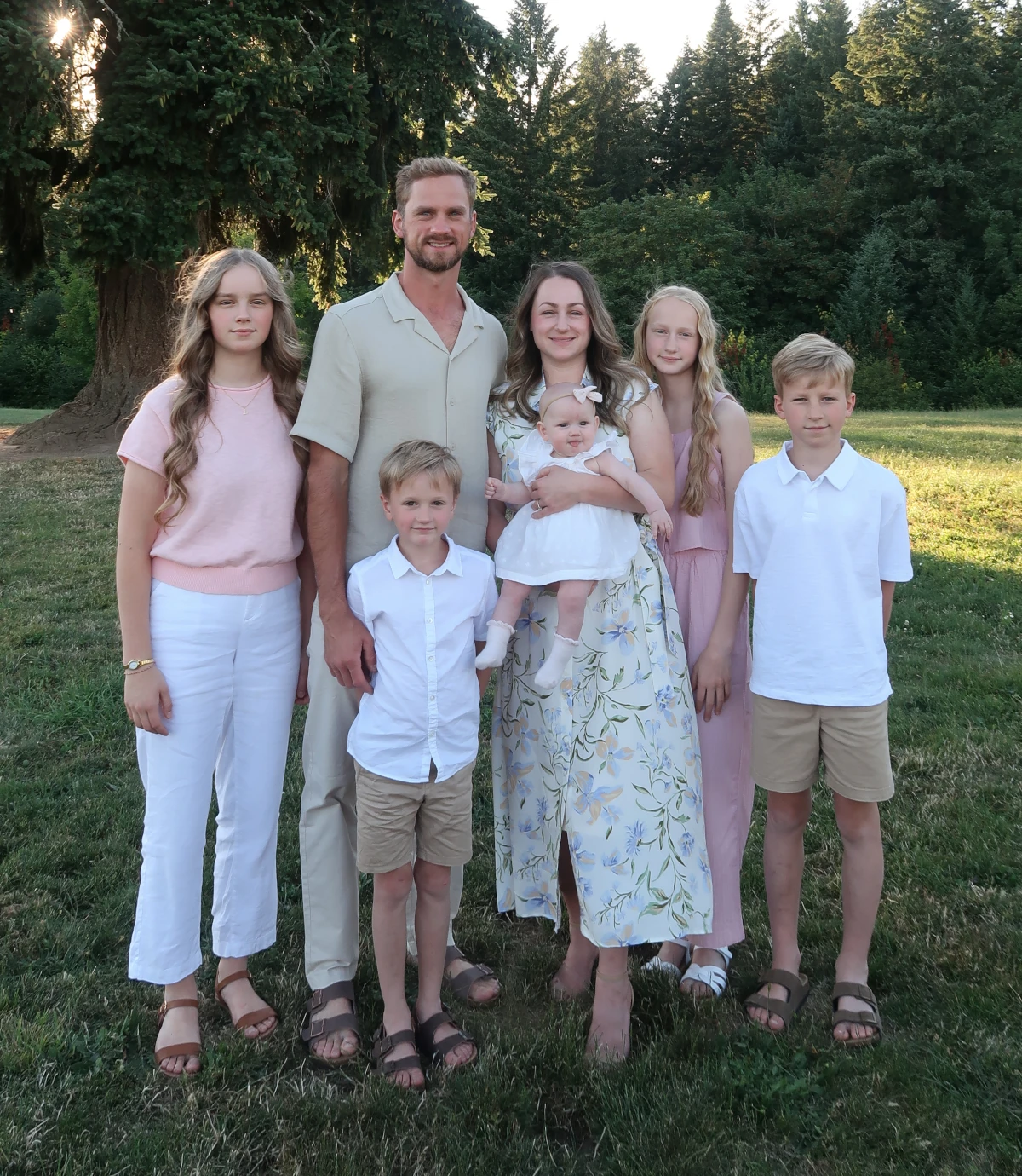 Terek Fencing owner with his wife and five children outdoors at sunset in the Pacific Northwest