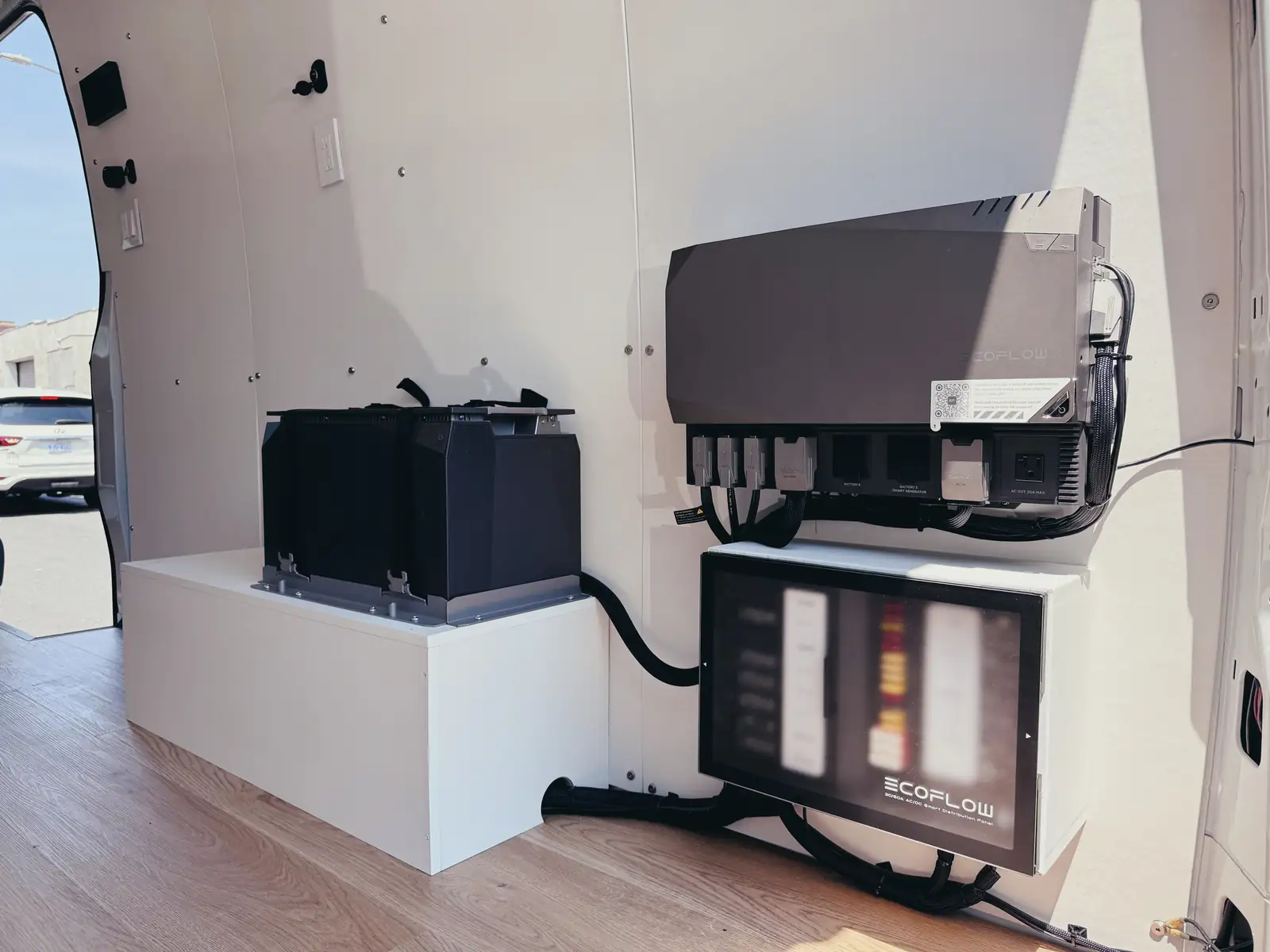 Mercedes Sprinter office interior with two black swivel seats, white folding table, white desk and blue floor with rails