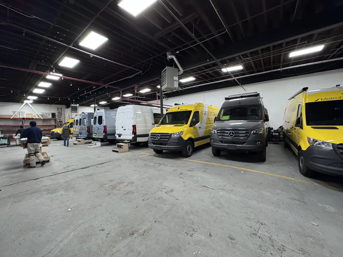 MetroPlusHealth vans and other Sprinters in production inside the Next Gen Vans shop