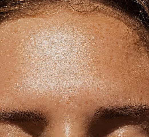 Close-up of lips and lower nose with a gold septum ring on a person with smooth skin.