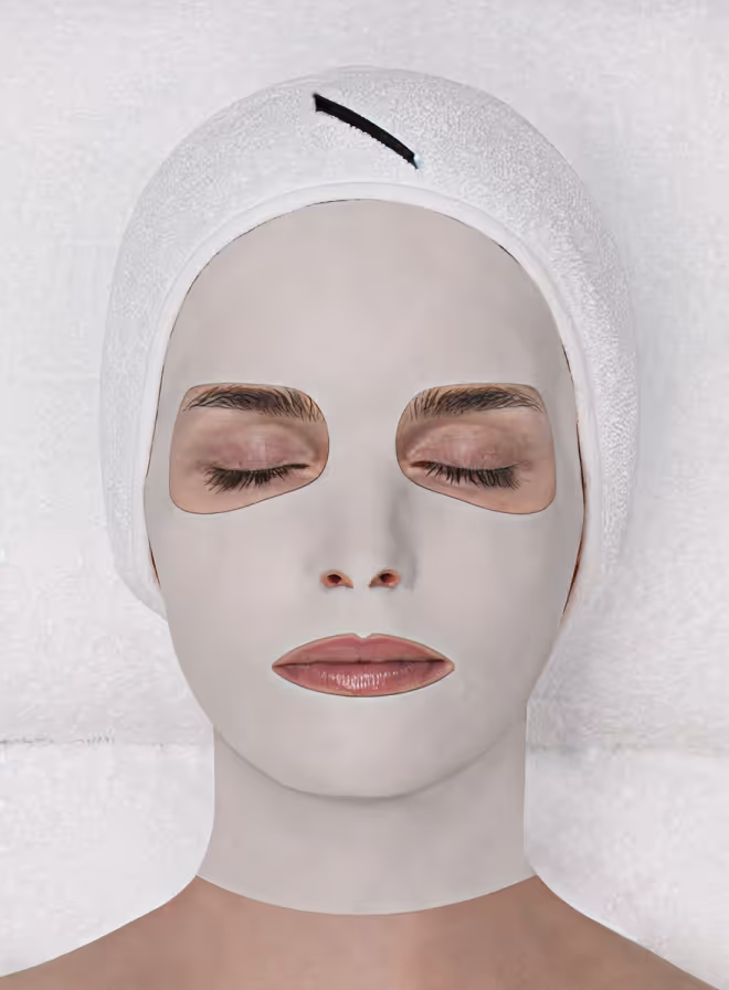 Close-up of a person's face showing closed eyes, nose, lips, and textured skin with small blemishes.