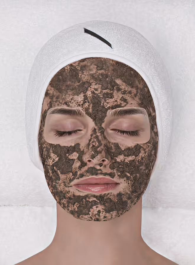 Close-up of a person's face showing closed eyes, nose, lips, and textured skin with small blemishes.