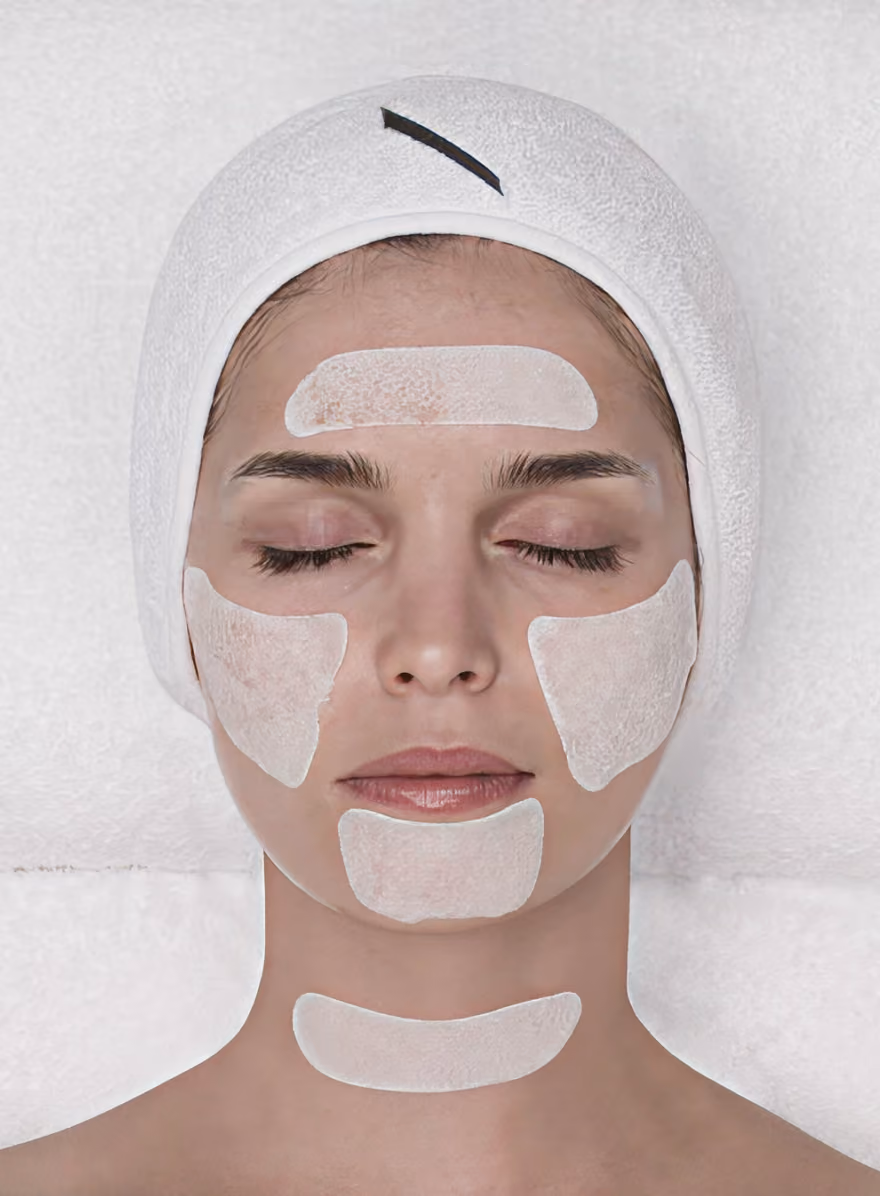 Close-up of a person's face showing closed eyes, nose, lips, and textured skin with small blemishes.