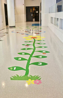 Numbered hopscotch flower vine floor decal in school hallway