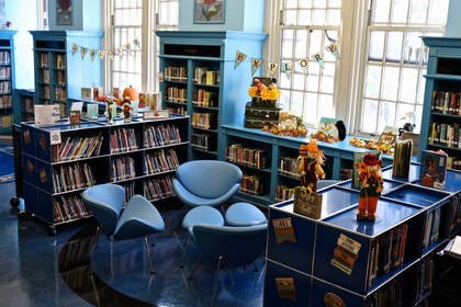 School library reading area with bookshelves and cozy seating