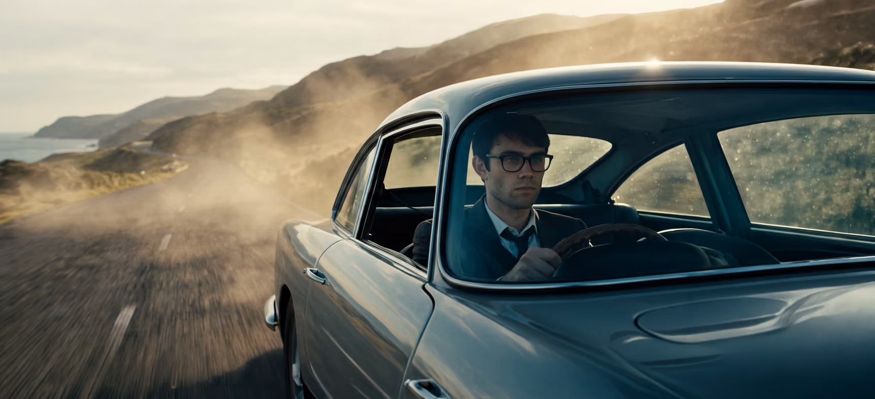Jake leaning against a classic car on a desert road