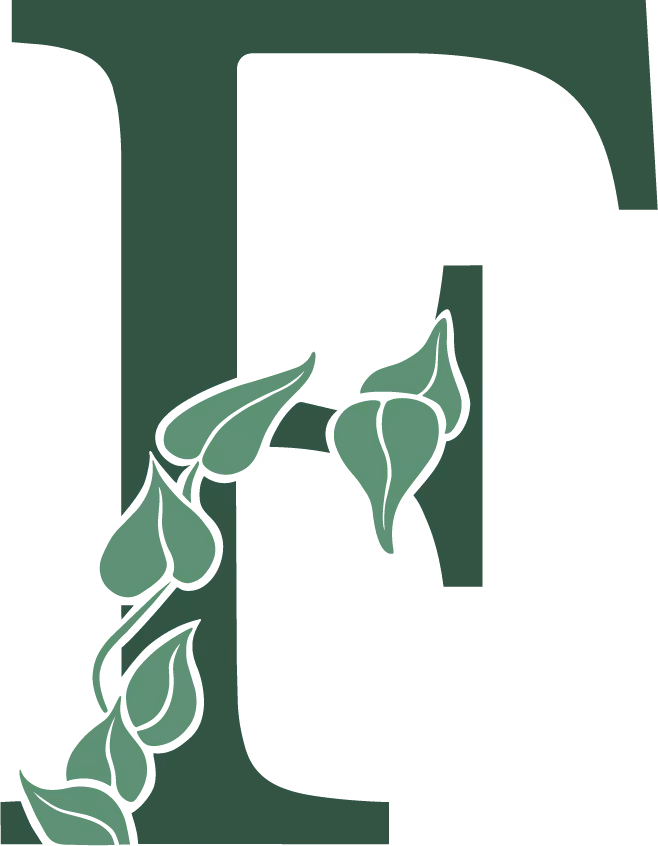 Green letter T with a trailing vine of stylized leaves wrapping around the lower left stem.