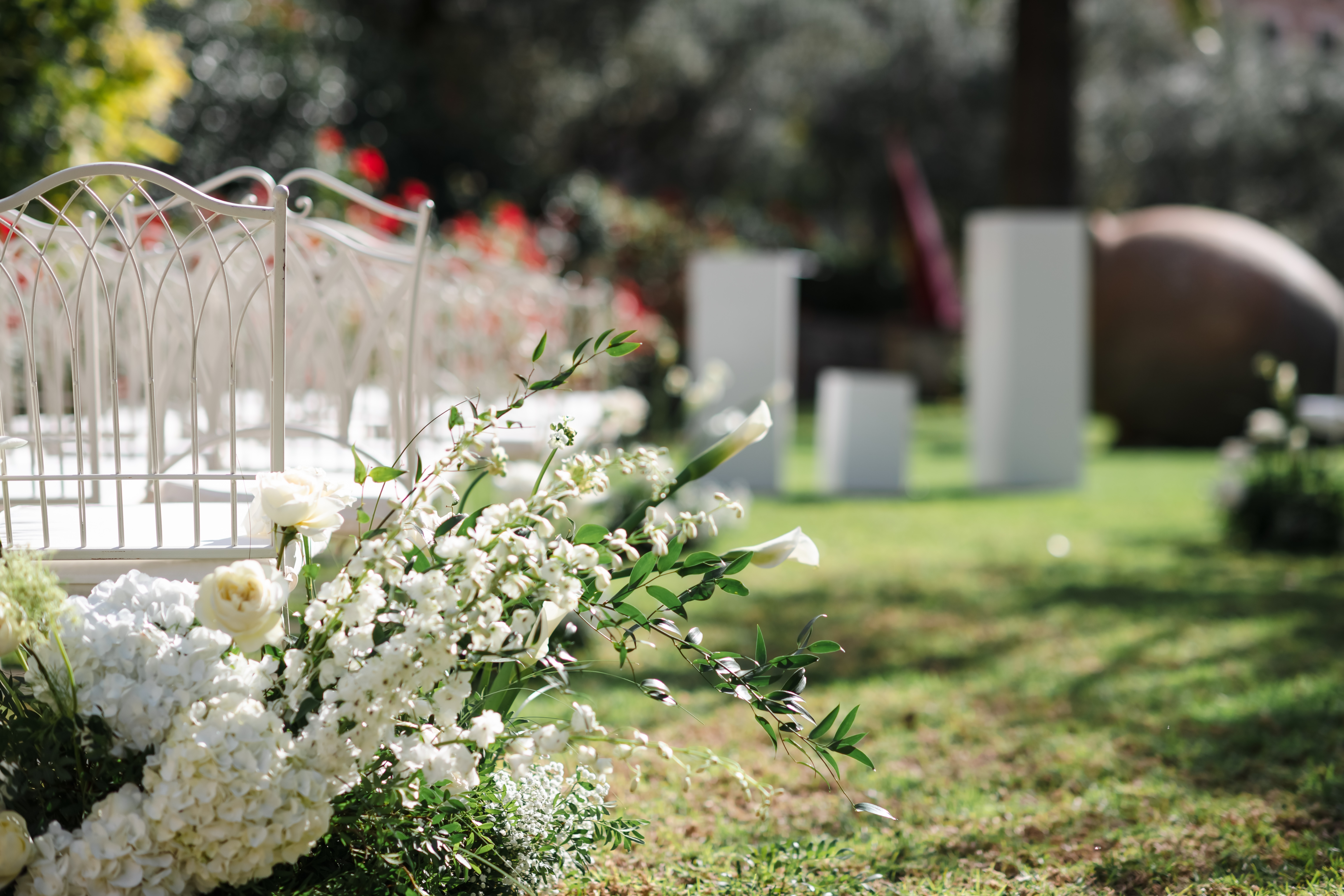 Wedding Ceremony with White Chairs and Florals