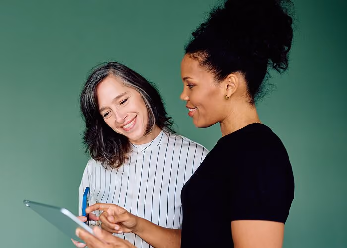 Two coworkers looking at technology