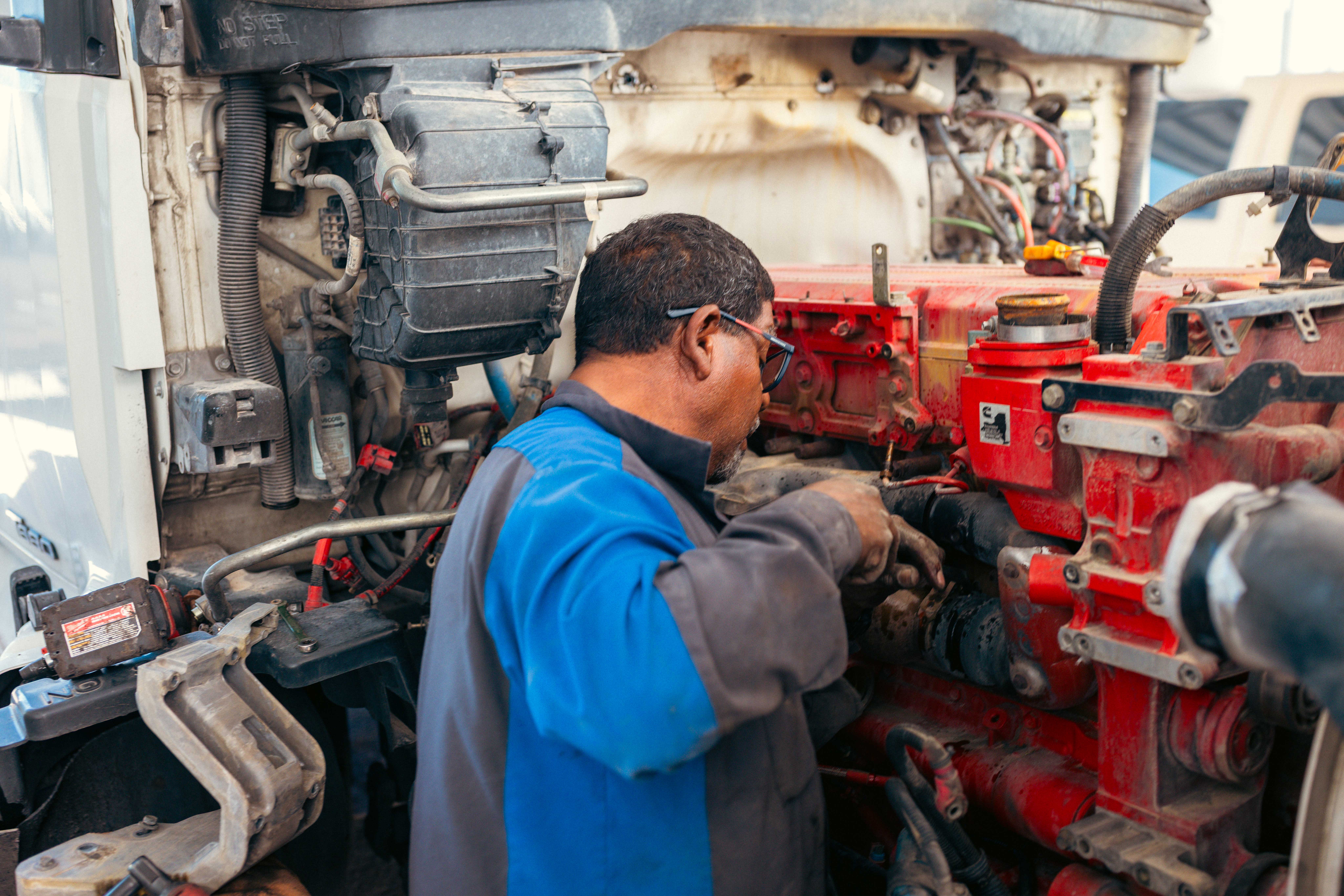 Worker standing beside a freight truck in a logistics yard