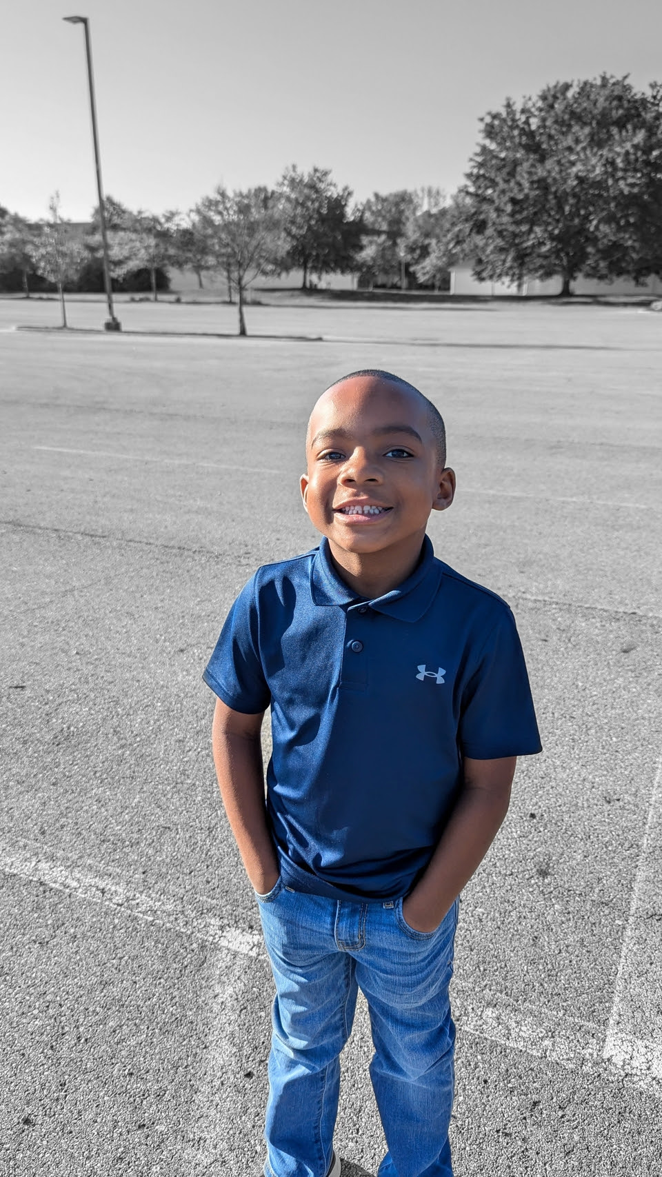 Young boy music student standing outdoors in a casual portrait