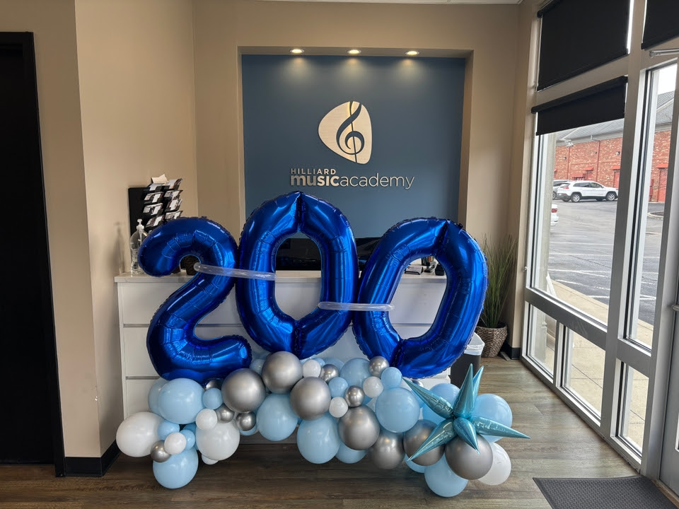 Blue balloon number display celebrating a studio milestone at Foundations Music Academy
