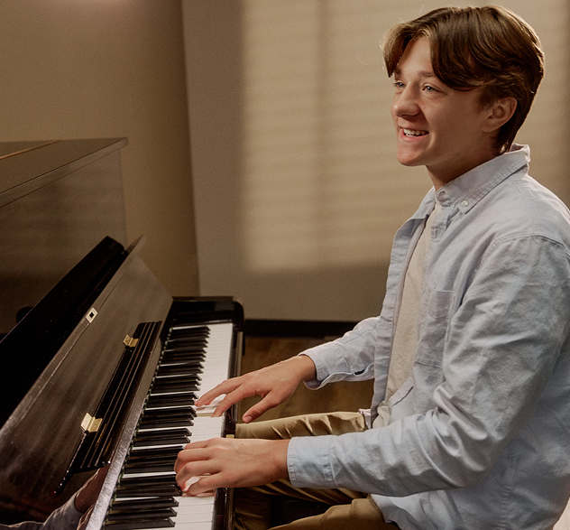 A student takes a piano lesson with a teacher at Foundations Music Academy