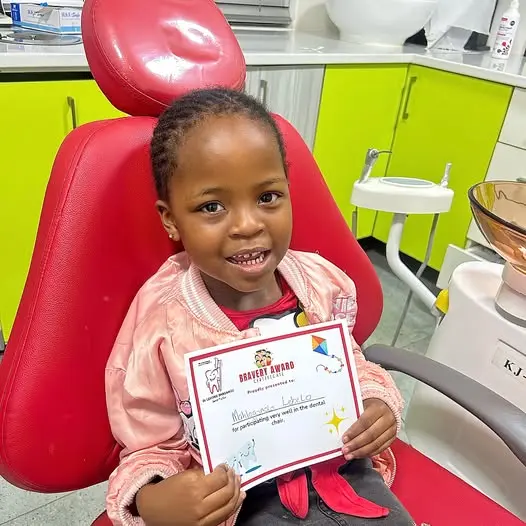 Child receiving a bravery award after a dental visit at Dr Lehong Shabangu Dental Practice