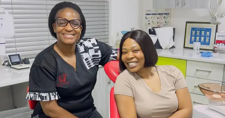 Dr Lehong Shabangu smiling with a happy teeth whitening patient in a dental clinic room in Centurion