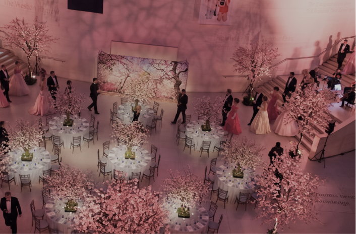 Guests beneath blossom installations at The Pink Ball, British Museum, London