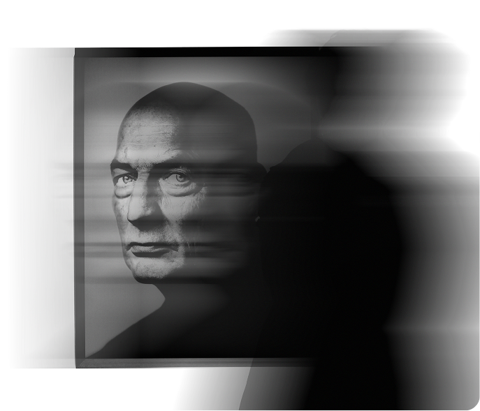 Portrait of a man seen through layered glass, motion blurred