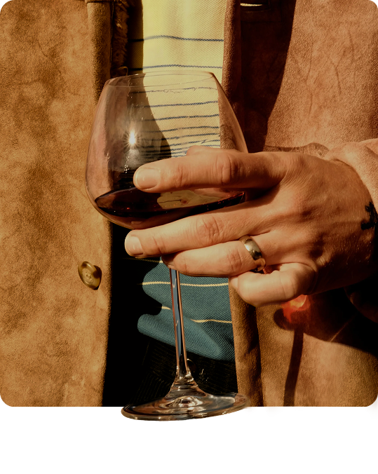 Hands holding a glass of red wine
