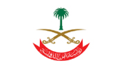 Emblem with two crossed swords, a palm tree above, and red Arabic script below on a white background.