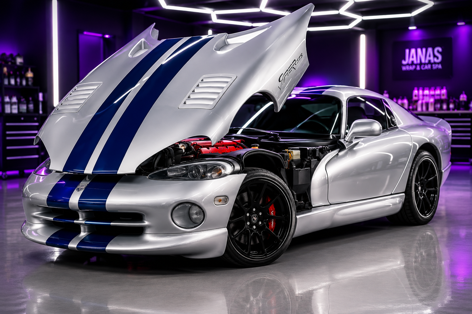 Silver Viper sports car with blue racing stripes and open front hood showing engine in purple-lit garage.