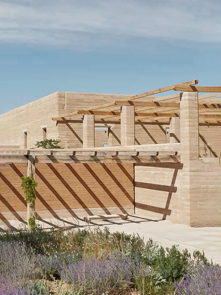Beaucastel - Studio Mumbai / Studio Méditerranée. Modern rammed earth building with wooden pergolas.