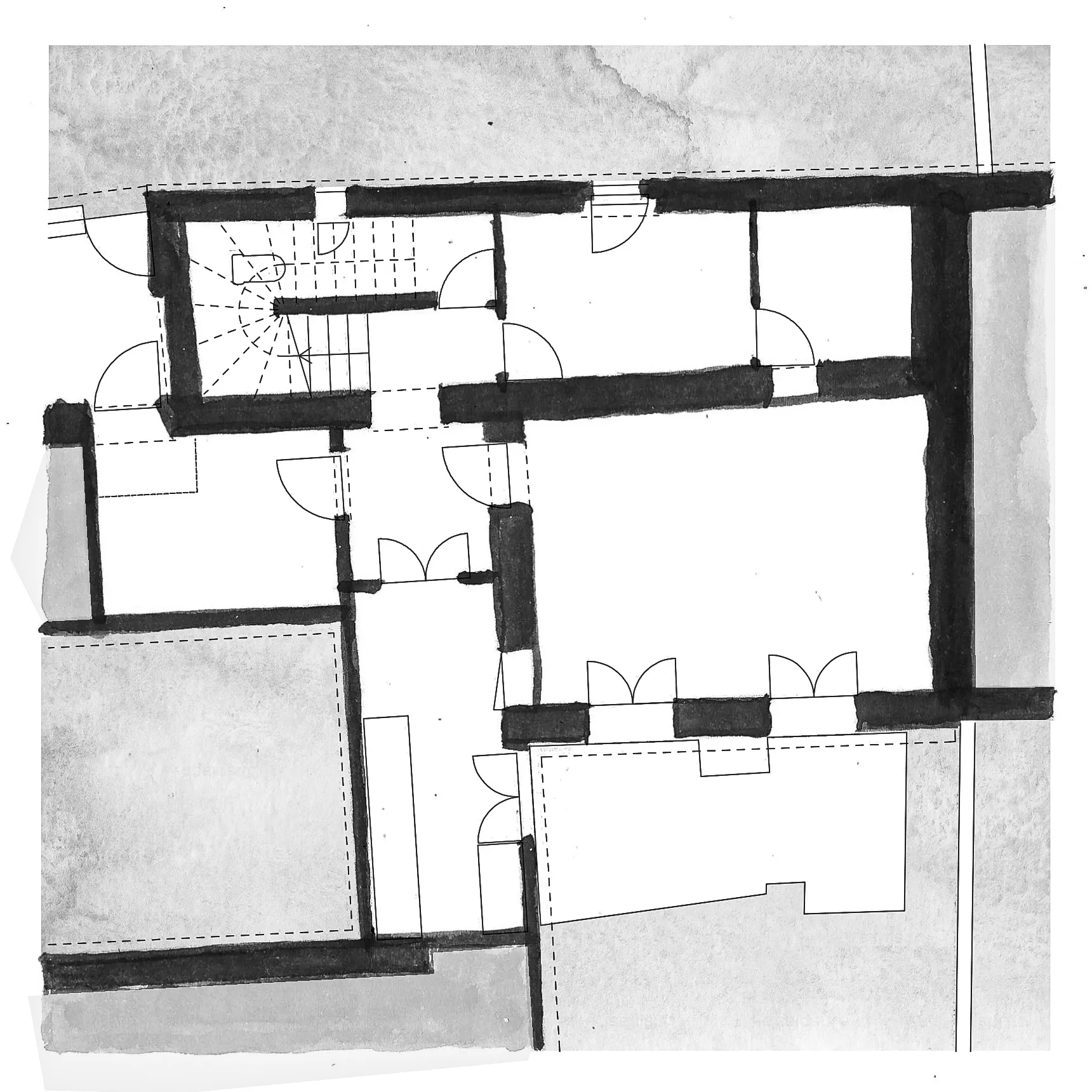 Black and white architectural floor plan with multiple rooms and staircases, thick walls highlighted.