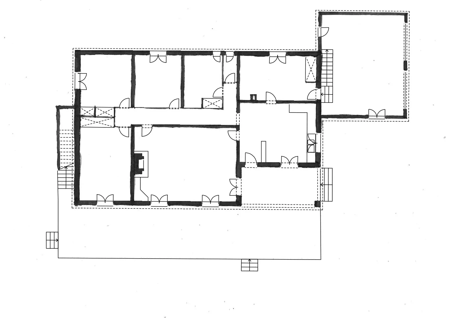 Floor plan of a single-story building with multiple rooms, doors, stairs, and a garage area.
