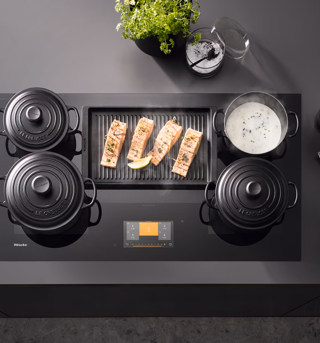 Miele induction cooktop with flush glass surface and touch controls