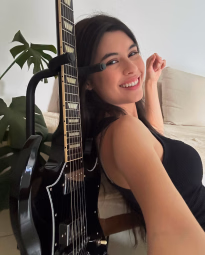Larissa Liveir playing guitar during rehearsal 