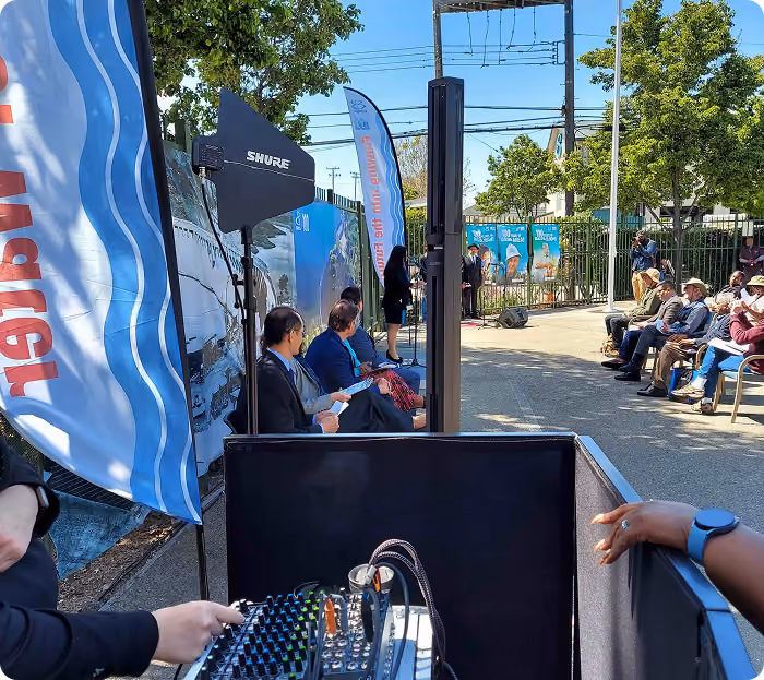 Outdoor sound booth with a mixing console at a street festival