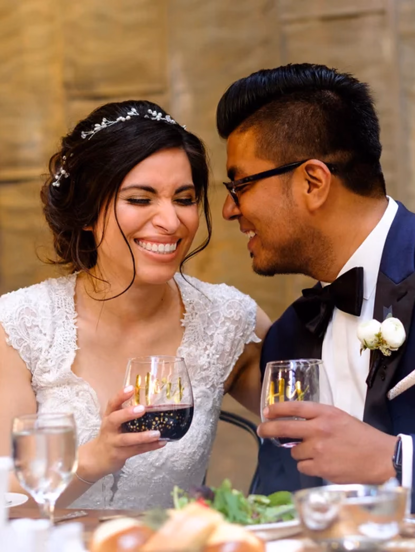 Image of a couple at their wedding dinner, smiling and joyful.
