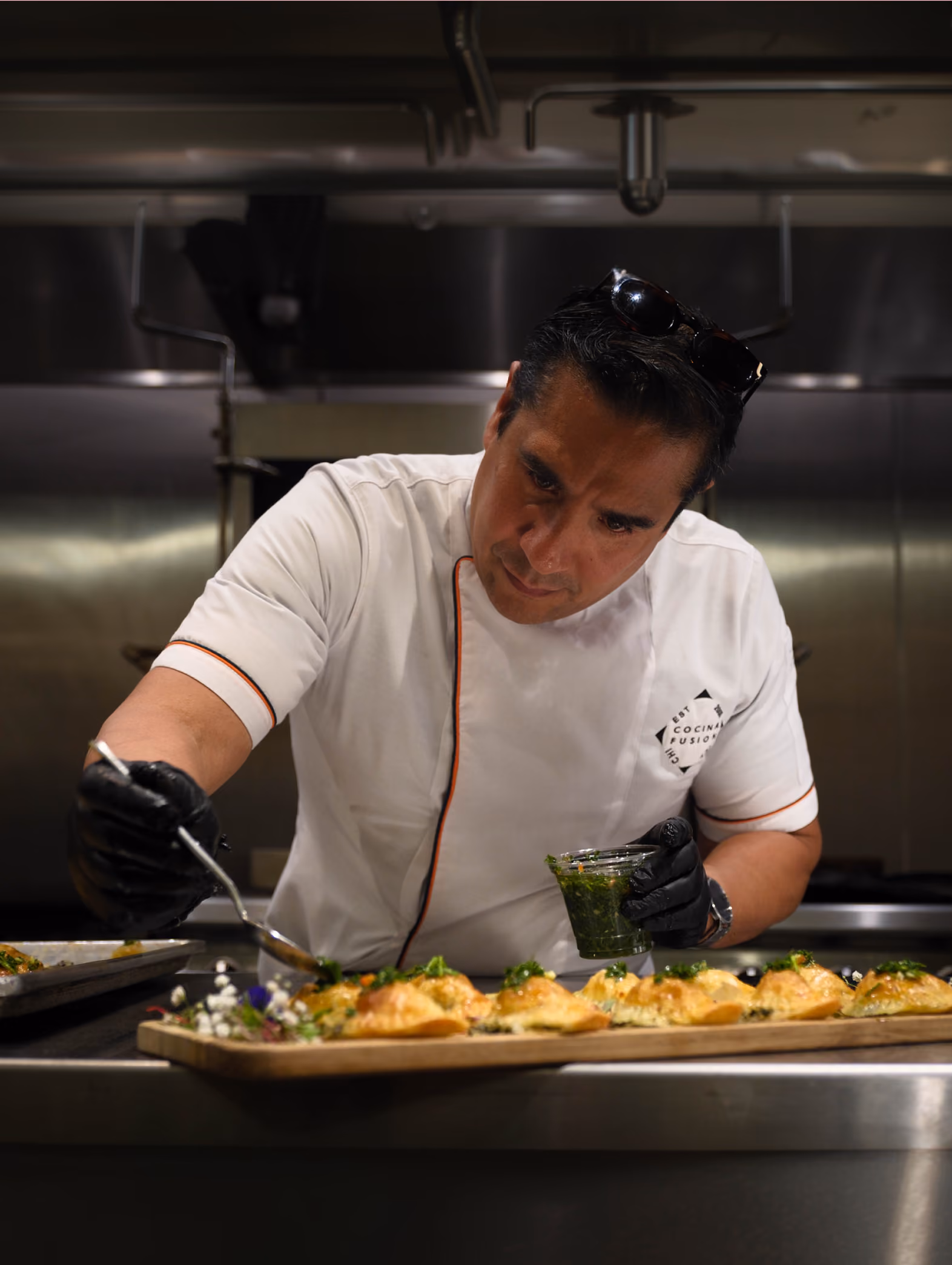 Image of Chef Anaxi carefully plating a dish.