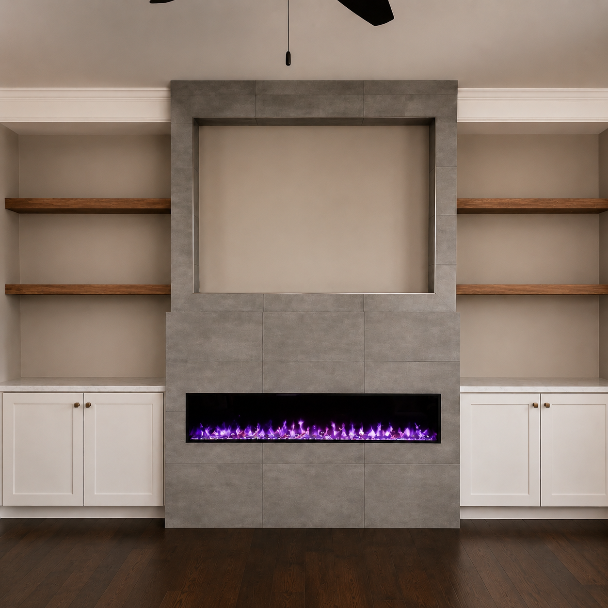 Gray tiled media wall with a recessed television, linear electric fireplace, floating wood shelves, and white base cabinets in Concord, NC.