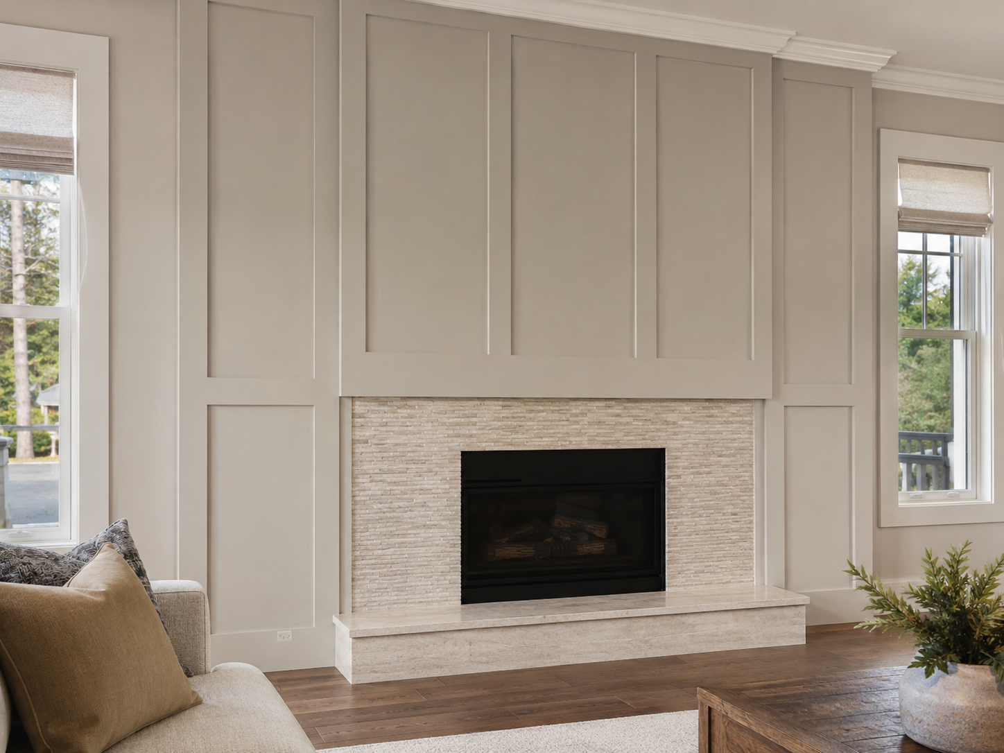 White paneled accent wall with a centered black fireplace, narrow textured stone surround, and raised stone hearth located in Stallings, NC.