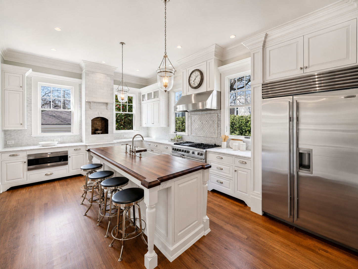 Bright white kitchen with a light tile backsplash, framed decorative tile detail above the range, and white custom cabinetry in Charlotte, NC.