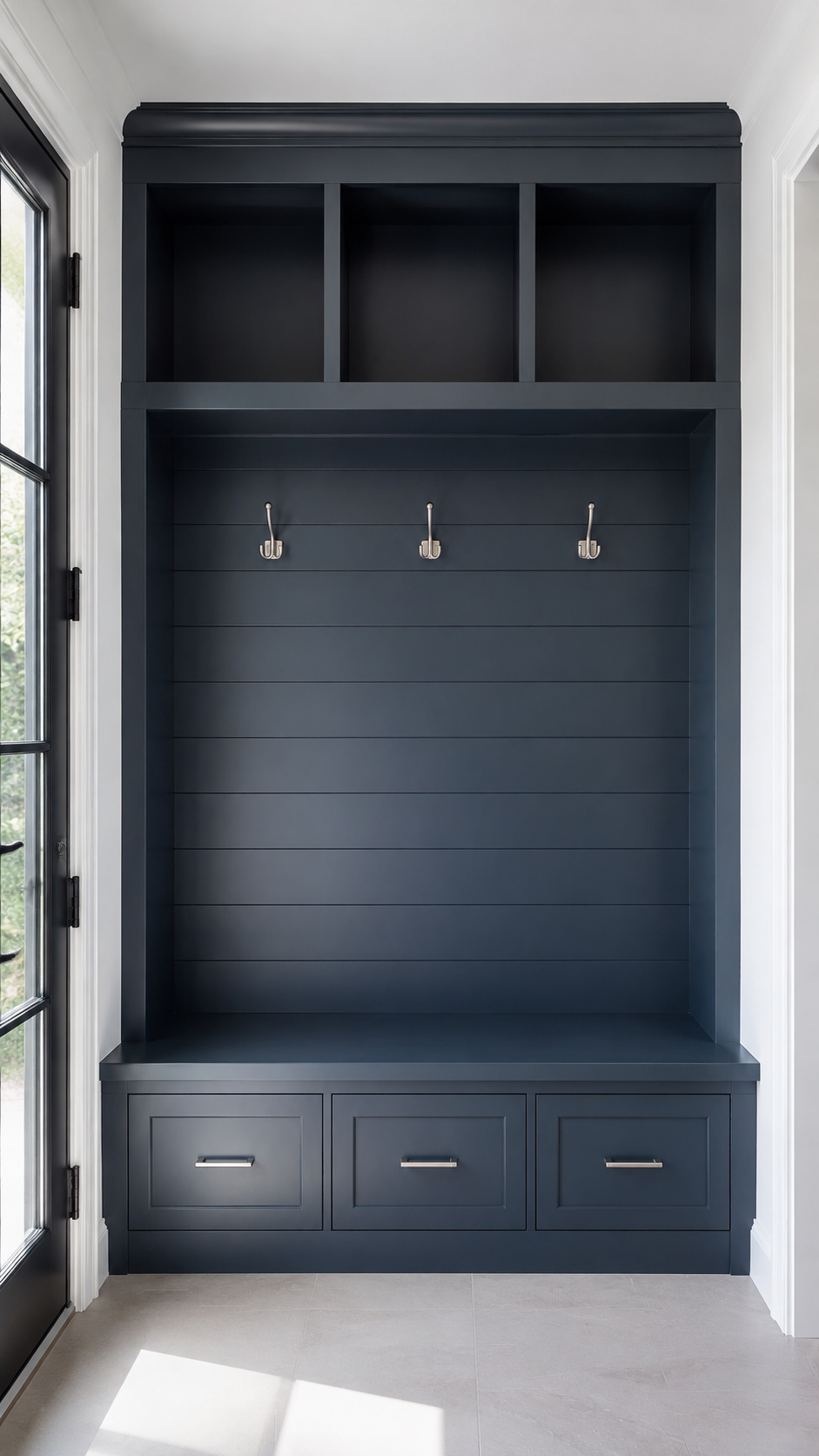 Floor-to-ceiling charcoal mudroom built-in with horizontal wall paneling, coat hooks, upper cubbies, bench seating, and storage drawers in Fort Mill, SC