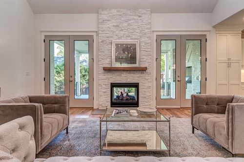 Side-by-side comparison of a fireplace surround and a full-height fireplace feature wall.